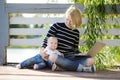 Young mother with her baby working or studying on laptop Royalty Free Stock Photo