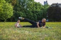 Young mother with her child do sports in the park