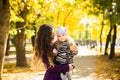 Mother and her child girl playing together on autumn walk in nature outdoors. Royalty Free Stock Photo