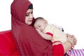 Young mother and her cute baby on sofa Royalty Free Stock Photo