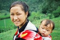 young mother with her cute child next to a rice field