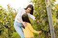 Young mother and her cute girl have fun in autumn vineyard Royalty Free Stock Photo