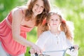 Young mother and her daughter on bicycle Royalty Free Stock Photo