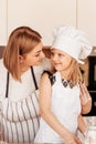 A young mother and her daughter have fun in the kitchen. They prepare a festive lunch together Royalty Free Stock Photo