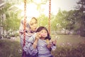 Young mother and her daughter playing soap bubble