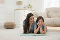 Young mother and daughter reading book at home, space for text Royalty Free Stock Photo