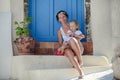 Young mother and her daughter sitting on doorstep Royalty Free Stock Photo