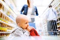 Young mother with her little baby boy at the supermarket. Royalty Free Stock Photo