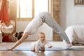 Young mother and little baby doing yoga exercises at home Royalty Free Stock Photo