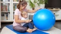 Young mother with her little baby son playing with fitball while doing fitness on mat at living room. Concept of healthcare, Royalty Free Stock Photo