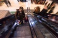 Young mother and her little daughter on escalator in shopping mall Royalty Free Stock Photo