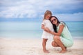 Young mother and her little daughter in hats have