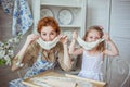 Young mother with her little daughter play with a dough Royalty Free Stock Photo