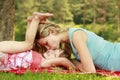 Young mother and her little daughter playing on grass Royalty Free Stock Photo