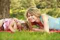 Young mother and her little daughter playing on grass Royalty Free Stock Photo