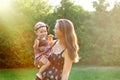 Young mother and her little daughter playing on grass Royalty Free Stock Photo