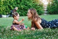 Young mother and her little daughter playing on grass Royalty Free Stock Photo