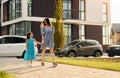 Young mother with her little daughter walking near the buildings Royalty Free Stock Photo