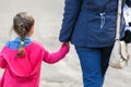 Young mother and her little daughter walking near the pond in the park Royalty Free Stock Photo