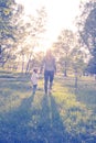 Young mother and her little daughter walking through park Royalty Free Stock Photo