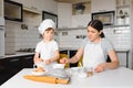 Young mother and her little son baking cookies together at home kitchen Royalty Free Stock Photo