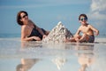 Young mother and her little son building sand Royalty Free Stock Photo