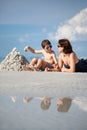 Young mother and her little son building sand castle at beach in Florida Royalty Free Stock Photo