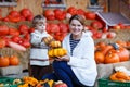 Young mother and her little son playing on pumpkin patch farm. Royalty Free Stock Photo