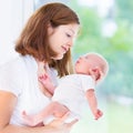 Young mother and her newborn baby at big window Royalty Free Stock Photo