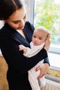 Young mother with her newborn baby at home. Happy family concept. Royalty Free Stock Photo