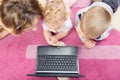 Young mother with her son and daughter on floor Royalty Free Stock Photo