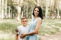 Young mother with her son in the park in the summer. Happy family walk in the park Royalty Free Stock Photo