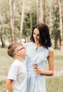 Young mother with her son in the park in the summer. Happy family walk in the park Royalty Free Stock Photo