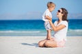 Young mother and her son playing at beach Royalty Free Stock Photo