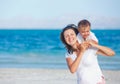 Young mother and her son playing at beach Royalty Free Stock Photo