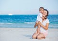 Young mother and her son playing at beach Royalty Free Stock Photo