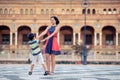 Young mother and her son playing outdoors in city Royalty Free Stock Photo