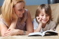 Young mother with her son read book on the sofa Royalty Free Stock Photo