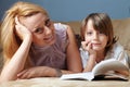 Young mother with her son read book on the sofa Royalty Free Stock Photo