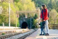 Young mother and her toddler son on a railway station. Mom and little child waiting for a train on a platform. Family ready to Royalty Free Stock Photo