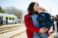 Young mother and her toddler son on a railway station. Mom and little child waiting for a train on a platform. Family ready to Royalty Free Stock Photo