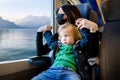 Young mother and her toddler son on a railway station. Mom and little child waiting for a train on a platform. Family ready to Royalty Free Stock Photo