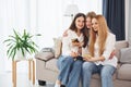 Young mother with her two daughters at home at daytime Royalty Free Stock Photo