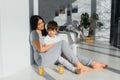 Young mother with her 4 years old little son dressed in pajamas are relaxing and playing in the bedroom at the weekend together, Royalty Free Stock Photo