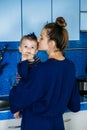 Young mother holding cute baby daughter in kitchen. Happy family mother and baby toddler girl cooking food at home Royalty Free Stock Photo