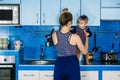 Young mother holding cute baby daughter in kitchen. Happy family mother and baby toddler girl cooking food at home Royalty Free Stock Photo