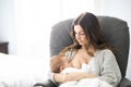 Young mother holding her baby child. Mom nursing baby. Royalty Free Stock Photo