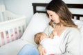 Young mother holding her baby child. Mom nursing baby. Royalty Free Stock Photo