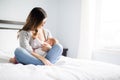 Young mother holding her baby child. Mom nursing baby. Royalty Free Stock Photo