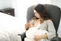 Young mother holding her baby child. Mom nursing baby. Royalty Free Stock Photo